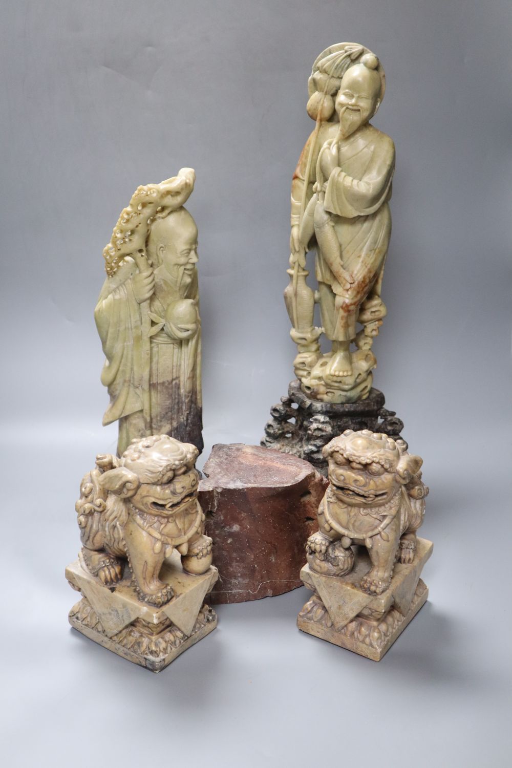 A pair of large Chinese soapstone figures of immortals, tallest 43cm and a pair of similar Buddhist lions